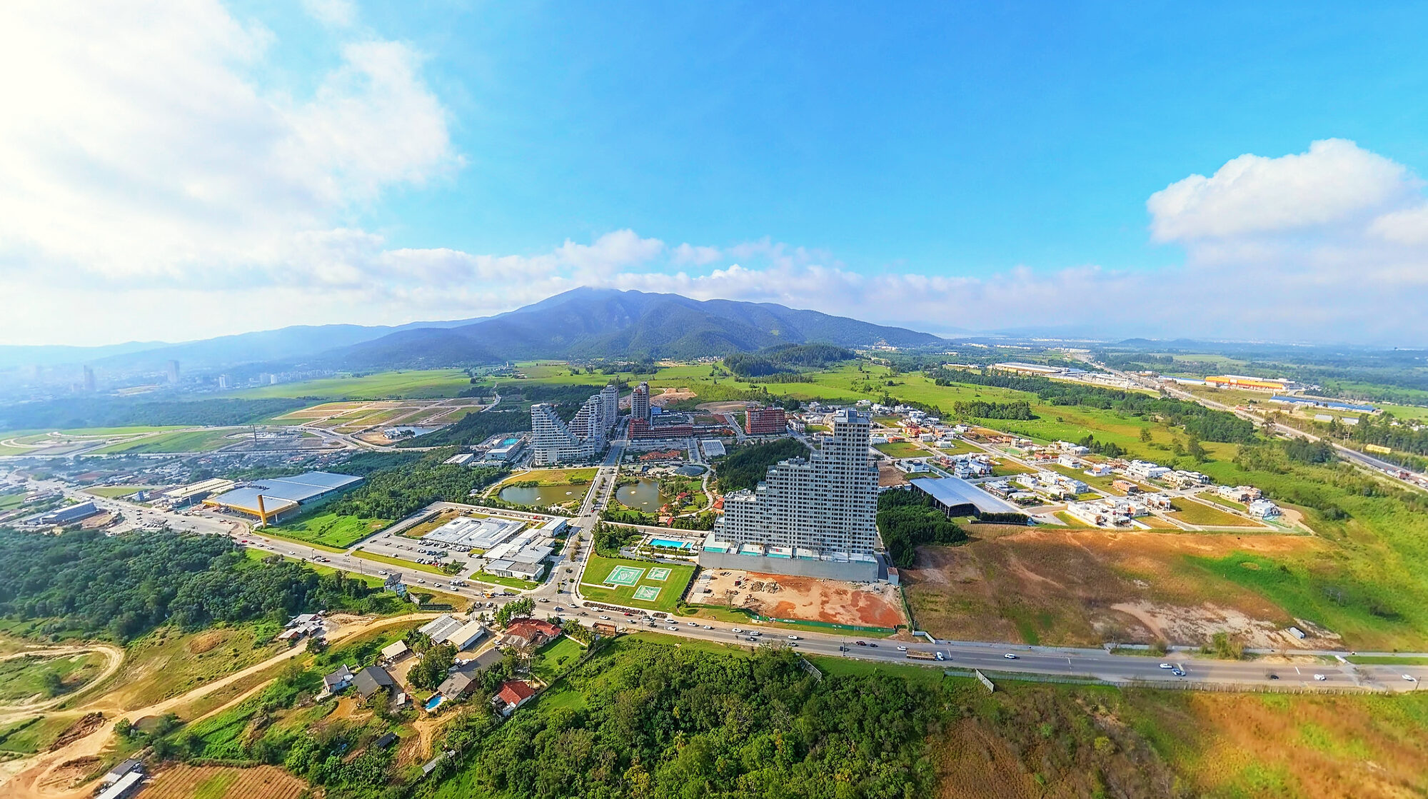 O Vivapark inteiro visto da BR-101, com a serra atrás, setembro de 2026